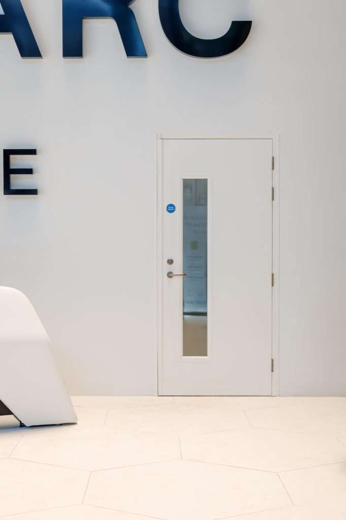 White steel fire door with emergency exit signage