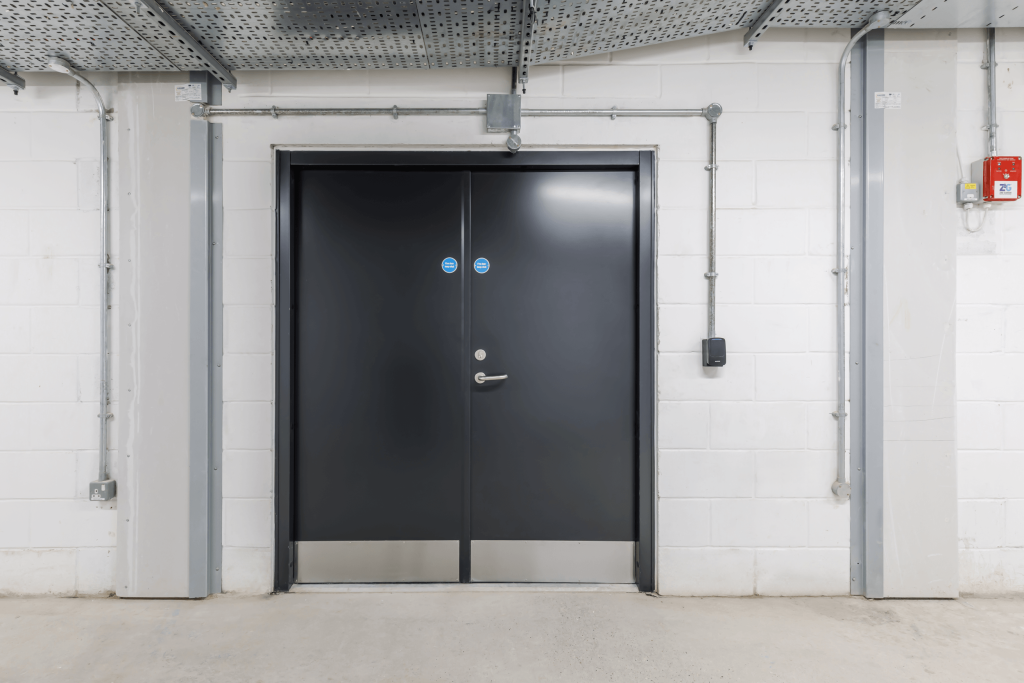 Black steel smoke doors in an office corridor