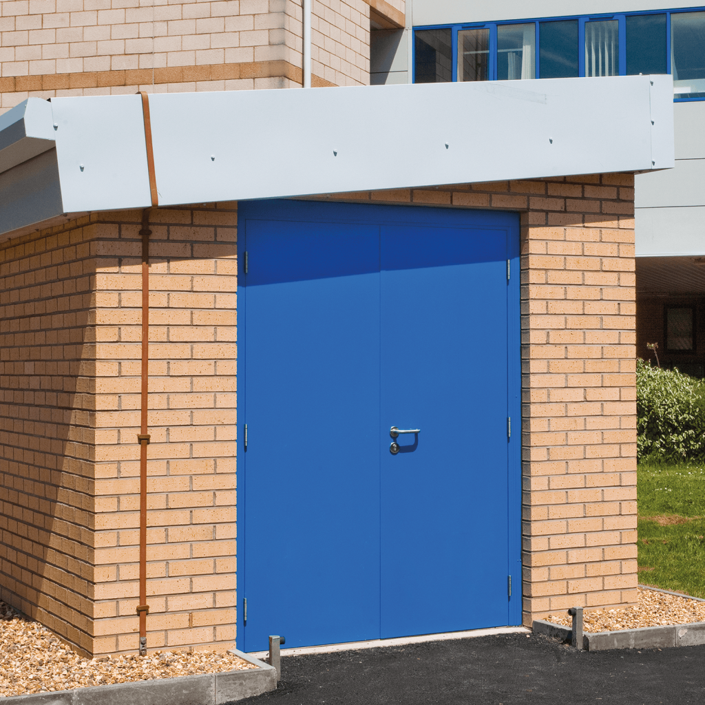 Blue steel thermally insulated fire door in a brick wall
