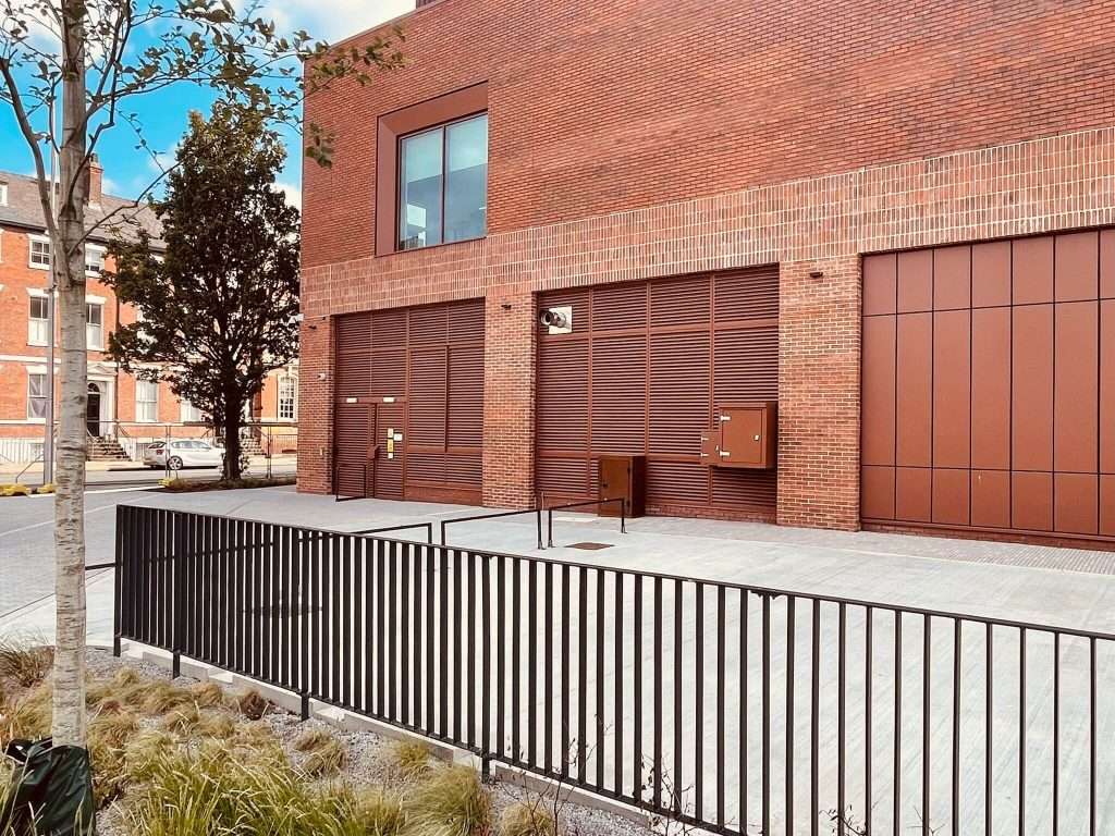Brick building with steel roller shutter door and entrance ramp