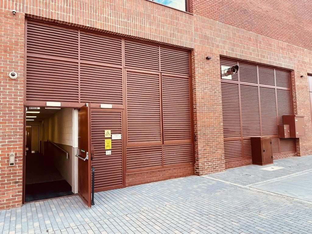Steel door open at a brick building entrance