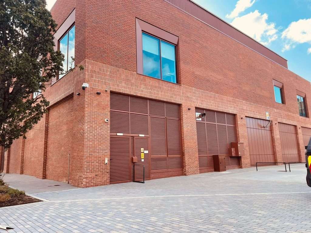 Brick building corner with steel roller shutter door