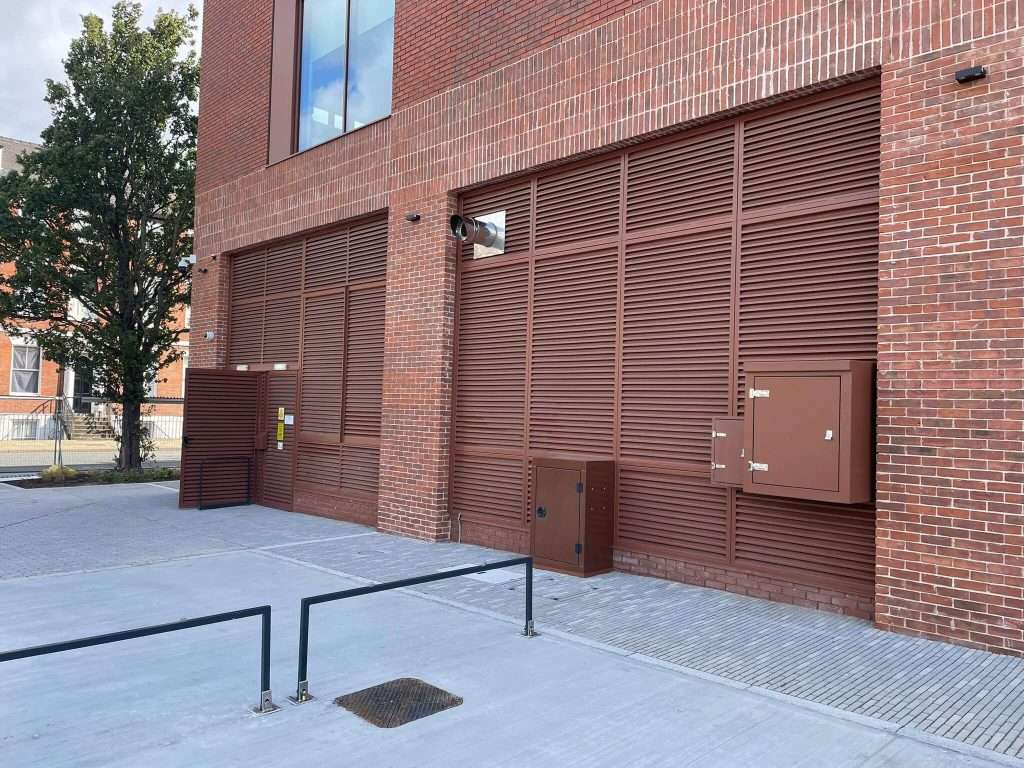 Brick building corner with steel roller shutter door