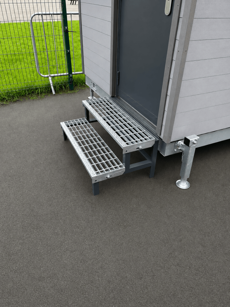 Galvanised steel step unit outside a building