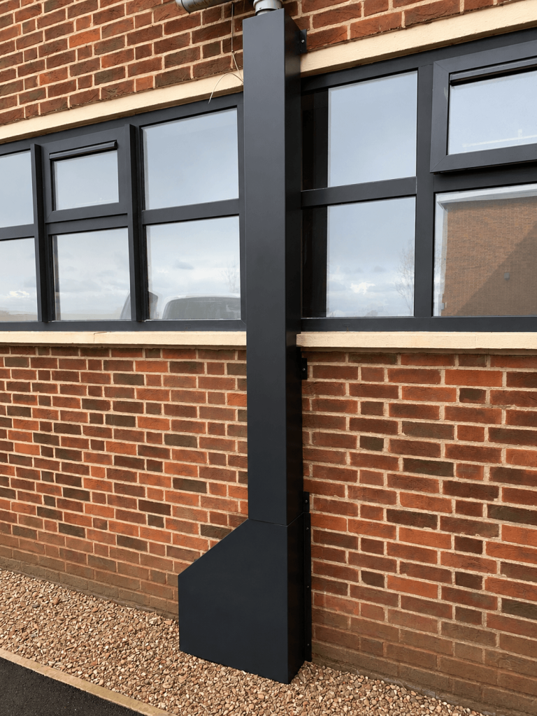 Steel guard protecting an external pipe run