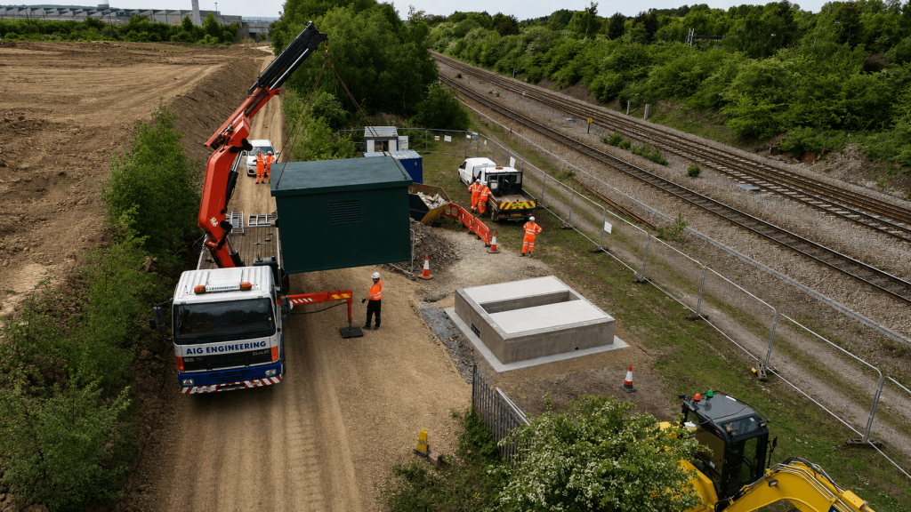 Steel enclosure being transported by crane lorry