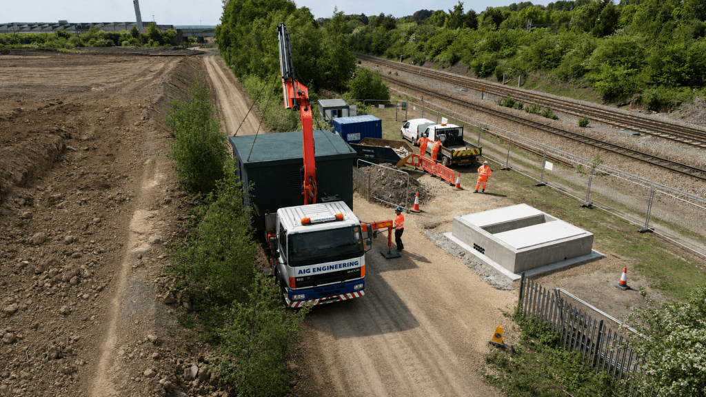 Steel enclosure being transported by crane lorry